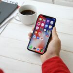 Smartphone on a desk, representative image for a discussion of on-device AI assistants