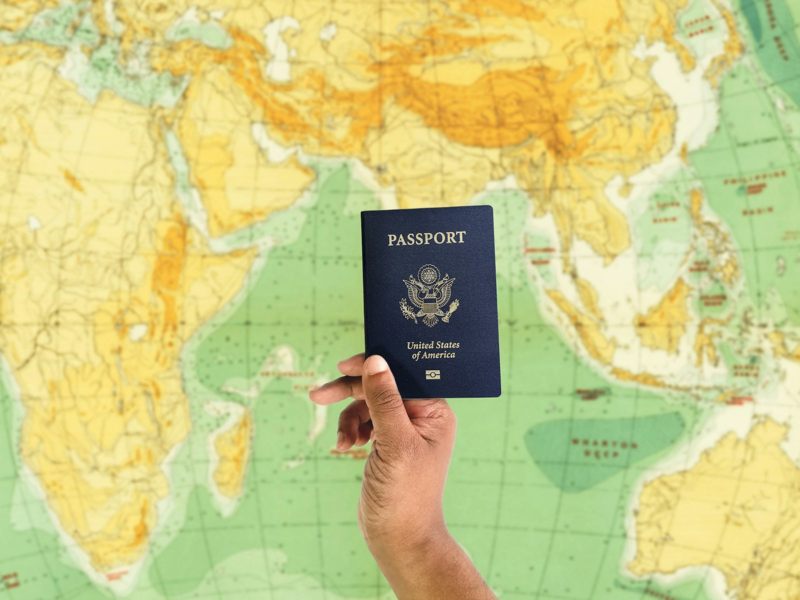 US Freezes Microsoft and Major IT Firms’ Green Card Applications Under PERM Passport held over a map illustrating international workers navigating US immigration rules
